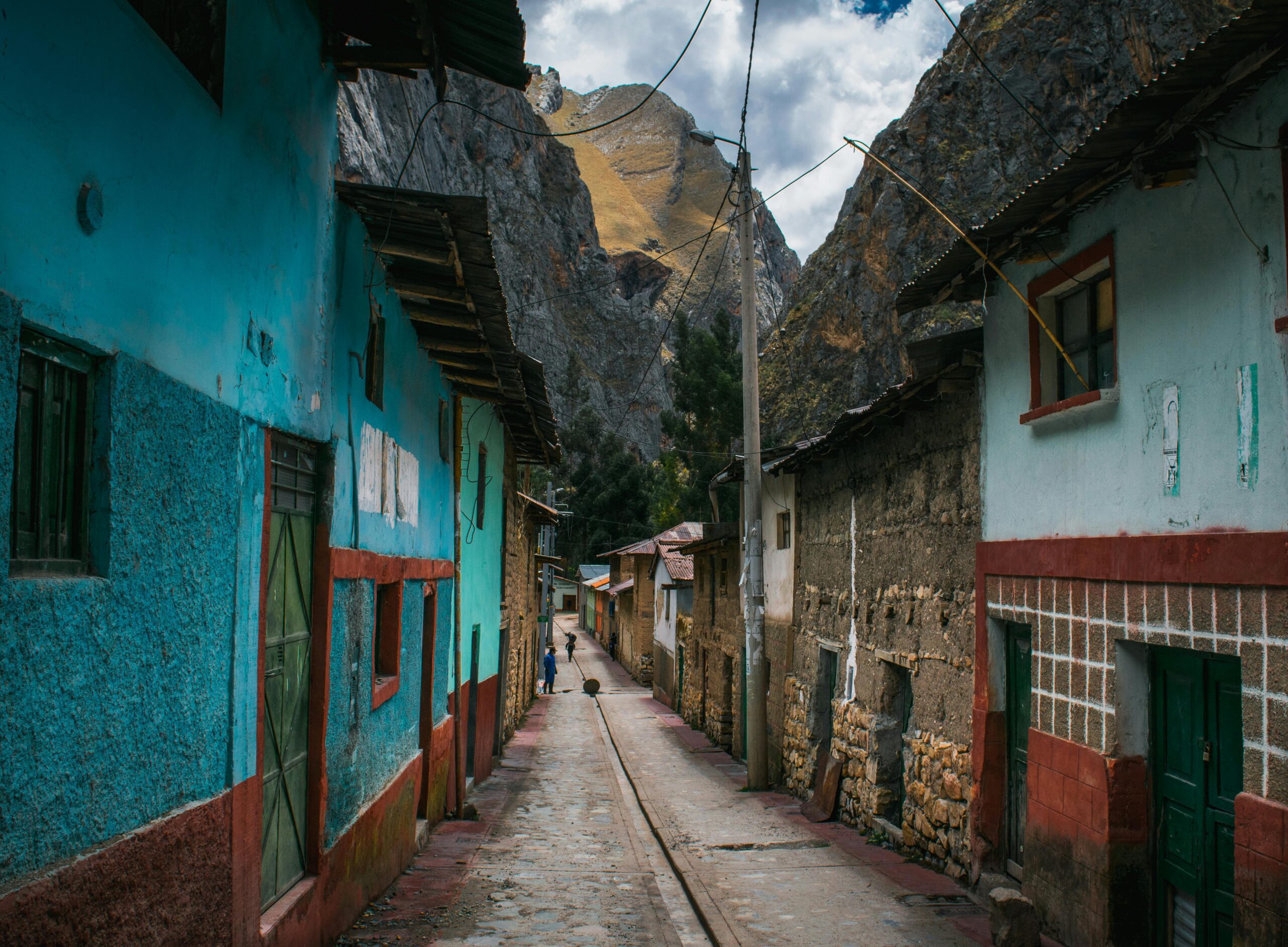 Explore the rustic charm of Yauyos, Peru with its colorful traditional architecture set against stunning mountains.